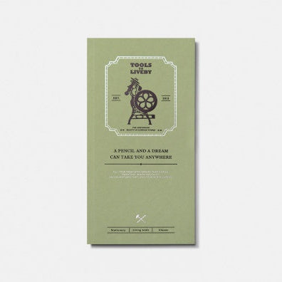 A vertical sage green notebook or book cover with a vintage-style illustration of a pencil and a horse wheel, featuring the text 'TOOLS TO LIVEBY' and 'A PENCIL AND A DREAM CAN TAKE YOU ANYWHERE', shown on a light gray background.