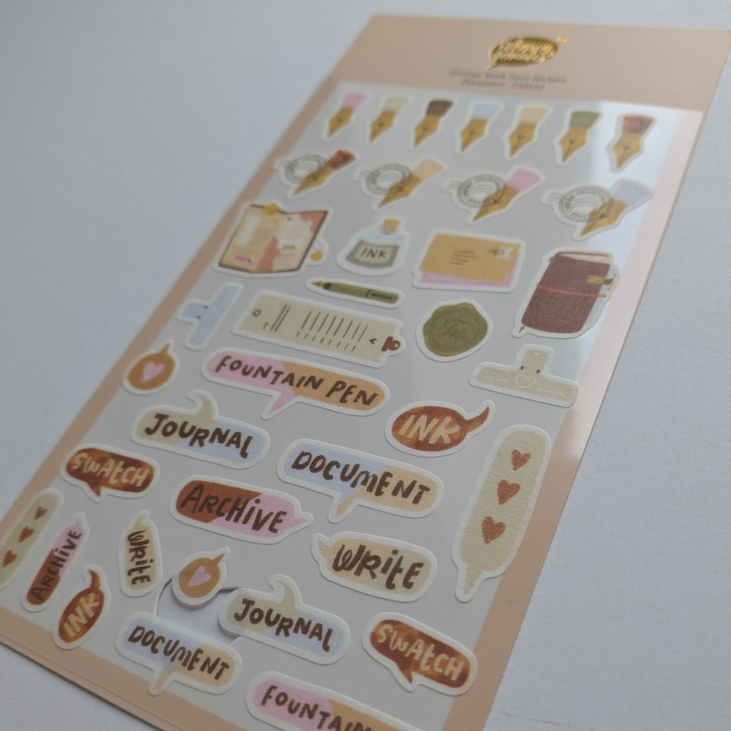 A sheet of cute, pastel-colored planner stickers featuring journaling and office-themed illustrations like fountain pens, books, and speech bubbles with words such as 'Fountain Pen', 'Journal', 'Document', and 'Archive'.