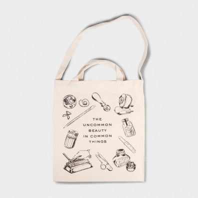 Tote bag showing stationery items - words stating the uncommon beauty in common things 