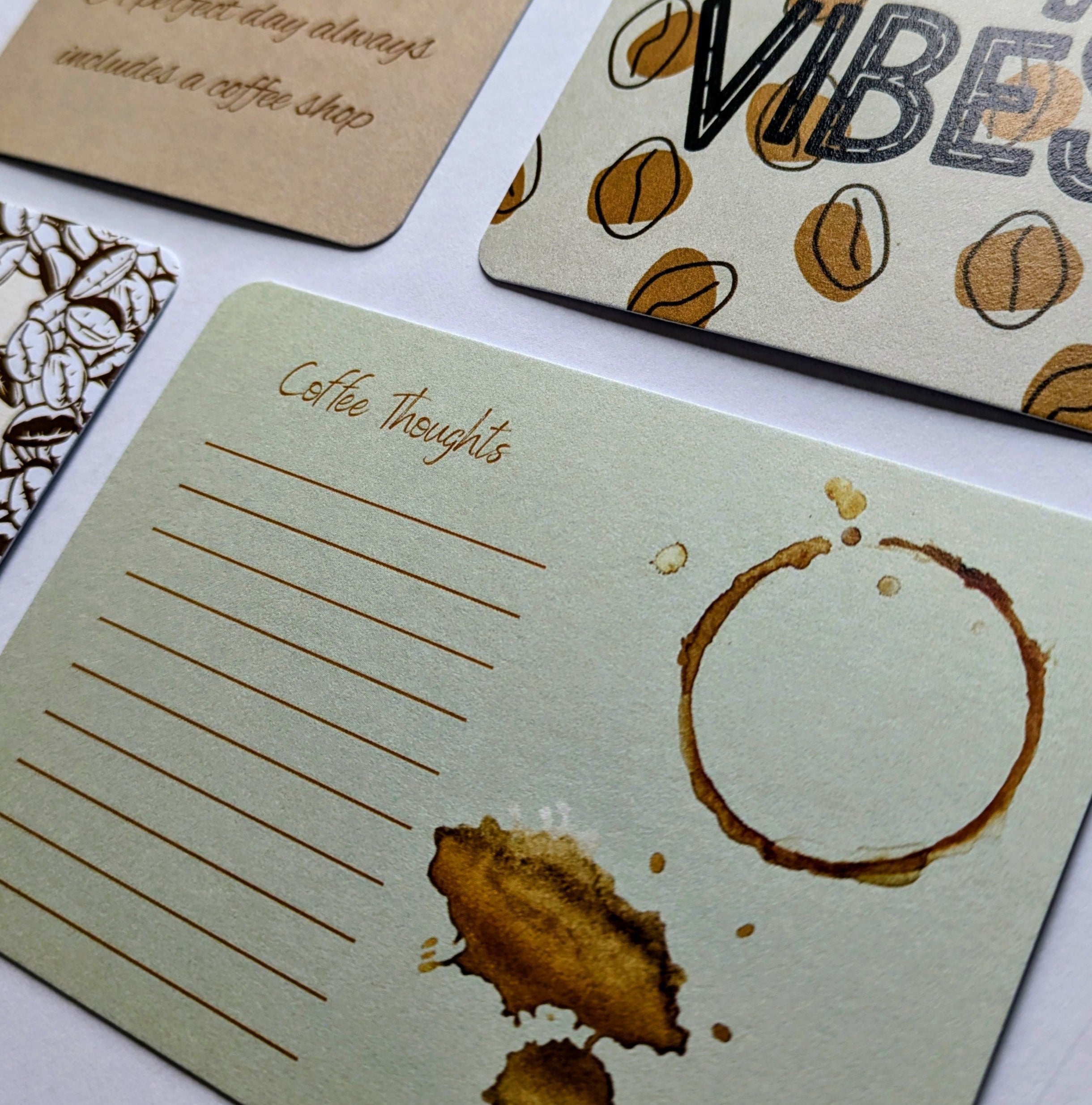 Set of coffee-themed cards with text and designs on a white surface