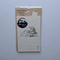 A packaged stationery pad labeled 'Stand Memo Mountain 20 sheets' with an animal-themed insert showing a bear hiker and the words 'Animal Adventure Club.'.