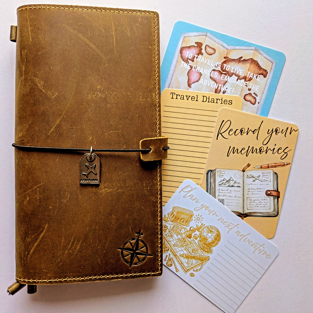 Brown leather travel diary with cards on a white background
