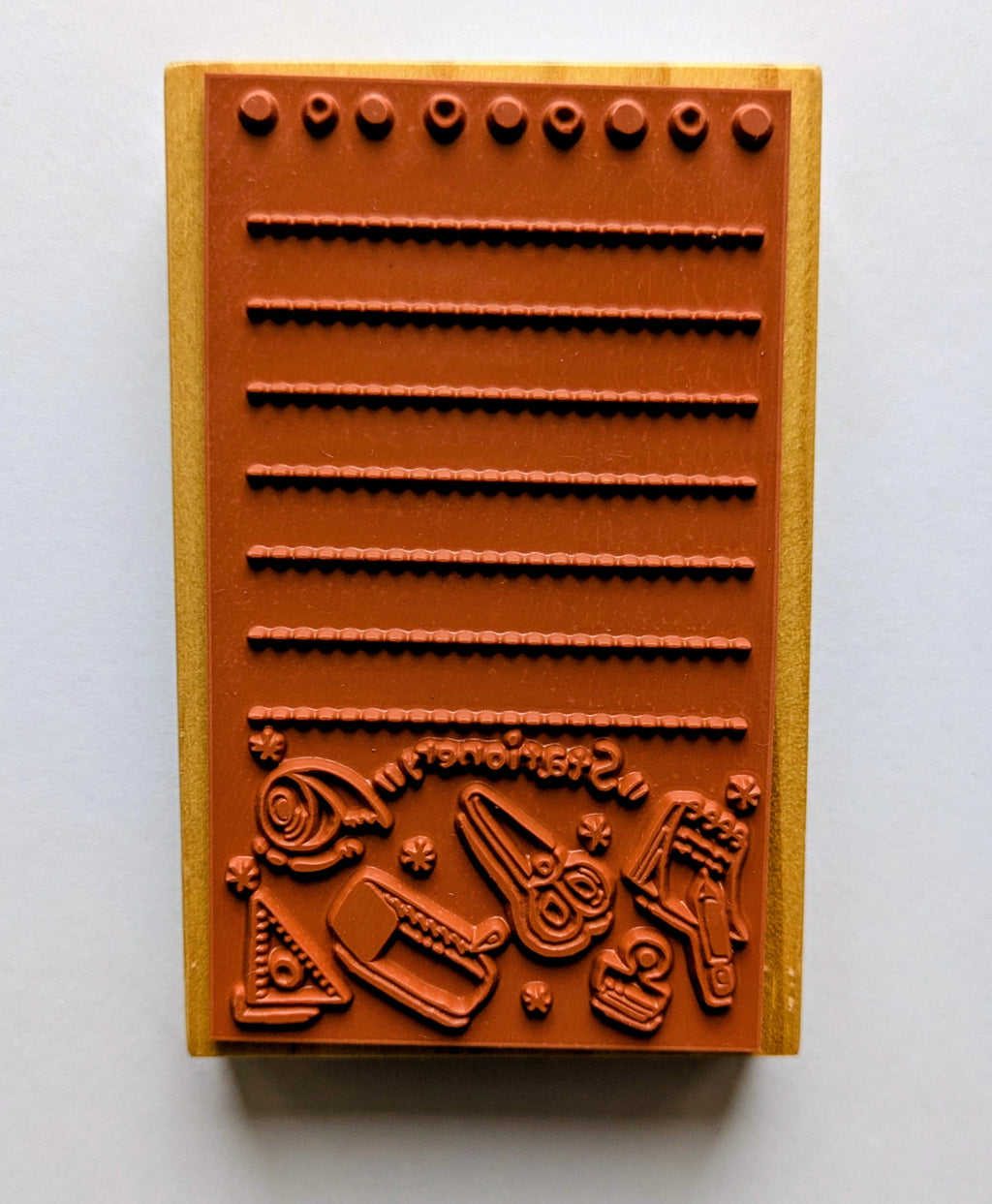 Wooden stamps showing embossed designs on a white background