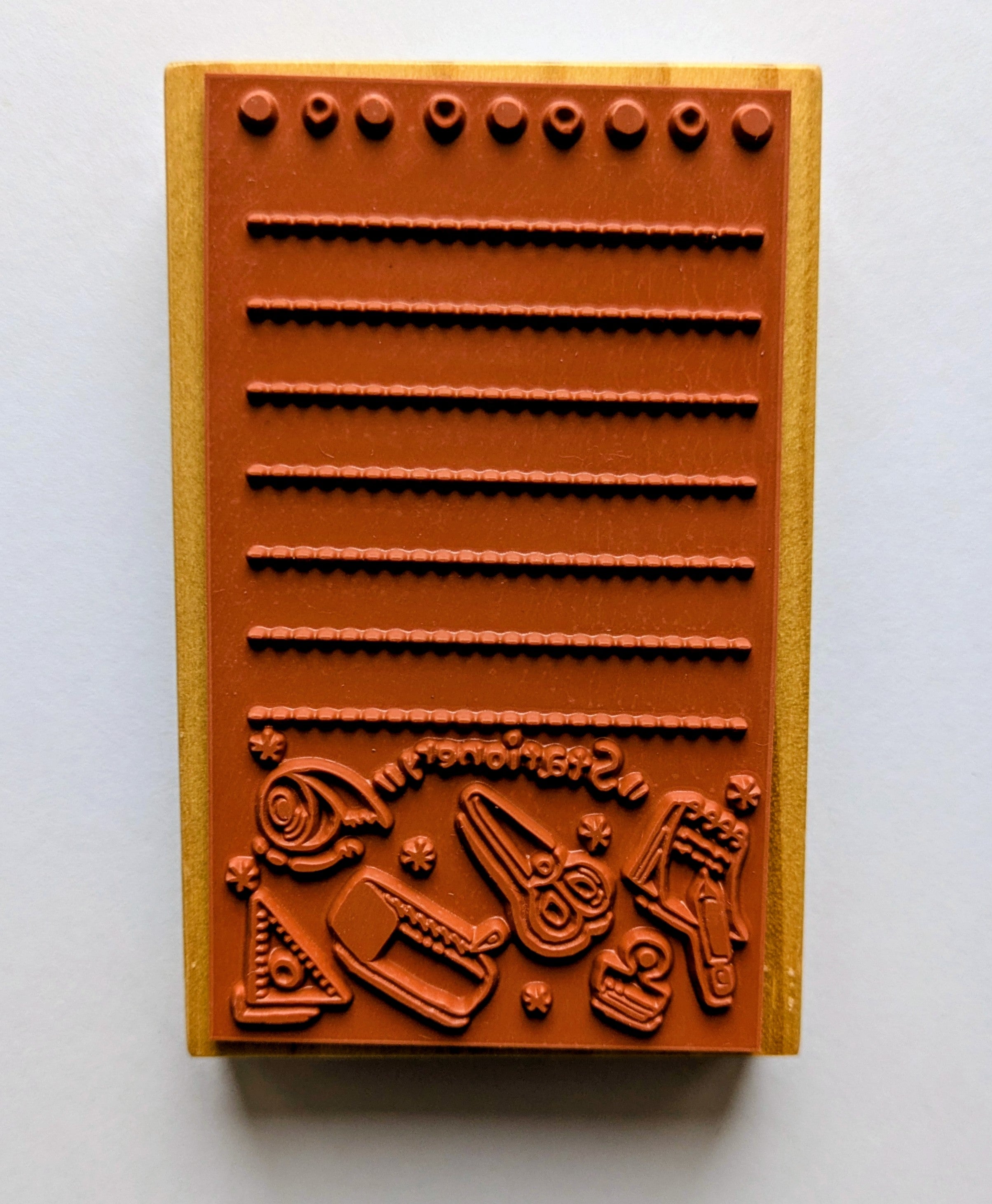 Wooden stamps showing embossed designs on a white background