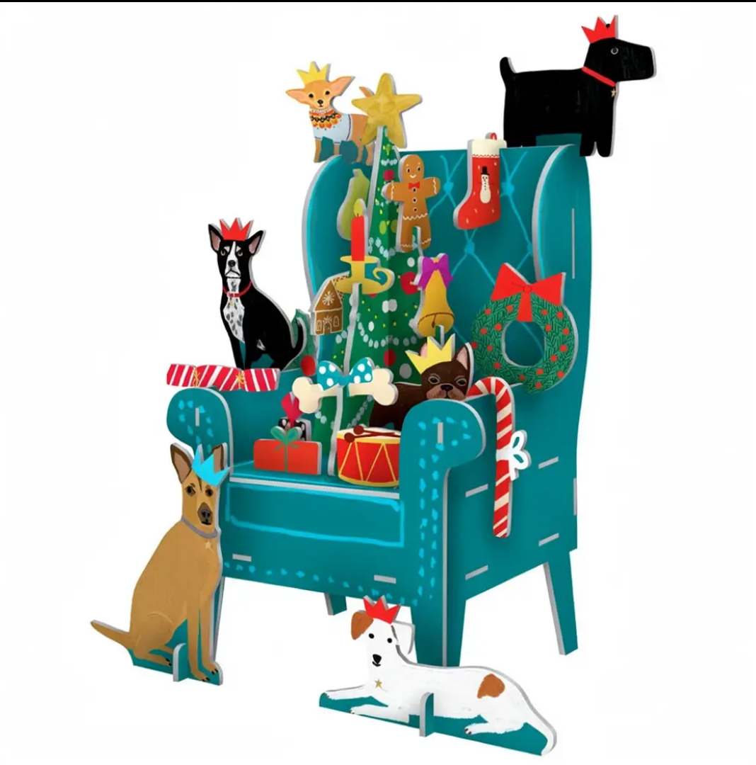 A festive illustrated Christmas advent calendar scene featuring a teal armchair surrounded by holiday decorations, gifts, candy canes, stockings, and several dogs in a stylized graphic layout on a white background.