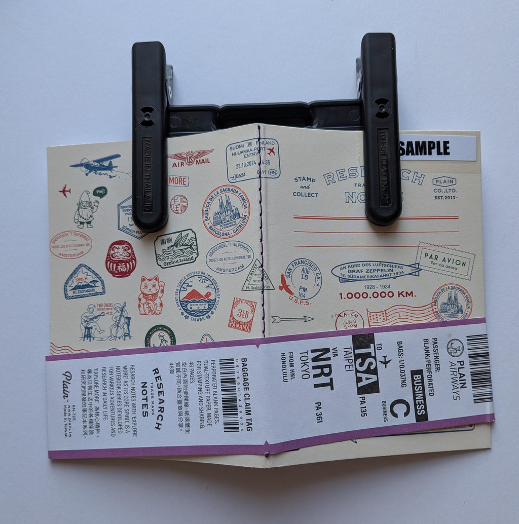 Campus KOKUYO clip holding a notebook