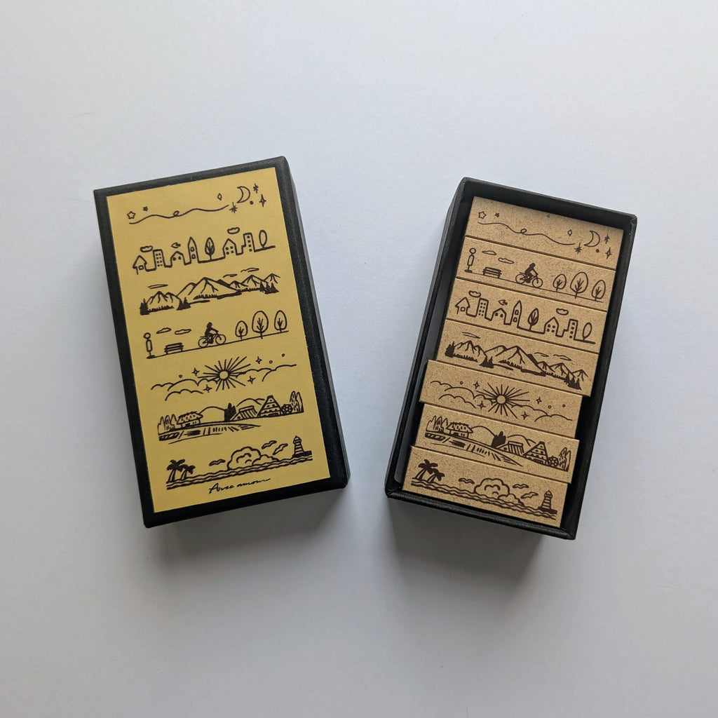 Scenery set of 7 mini boarder stamps presented in a black box on white background 