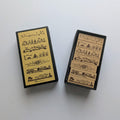 Scenery set of 7 mini boarder stamps presented in a black box on white background 