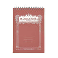 A spiral-bound notebook titled 'RESEARCH NOTES' with an ornate white decorative border on a dusty rose cover, shown against a plain white background.