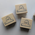 3 wooden rubber stamps with clip design on a light gray background