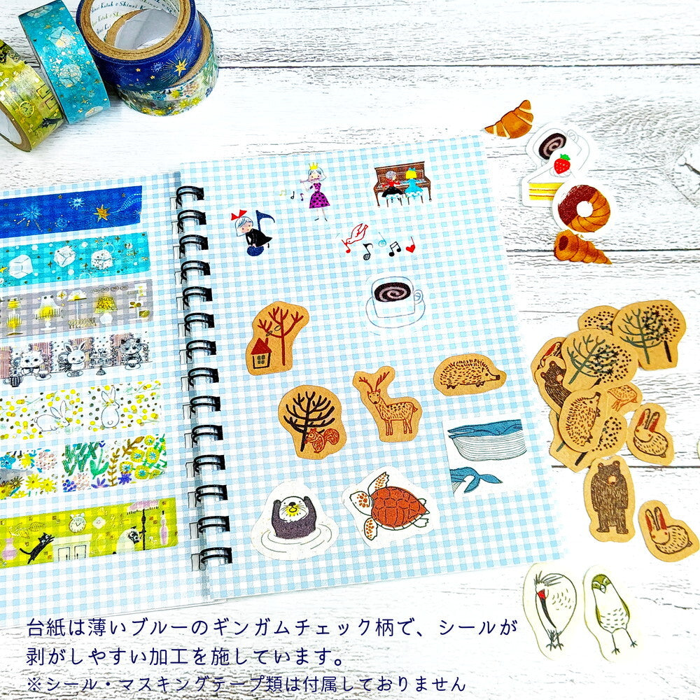 Sticker book with various stickers on a wooden surface