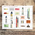 Sheet of stamps with stationery items on a wooden surface
