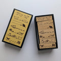 Sanby Cat-themed rubber stamps shown open, alongside their matching black and yellow storage box. The stamps feature various cat illustrations and the brand name Avec Amour is visible in the bottom-left corner of the box cover.