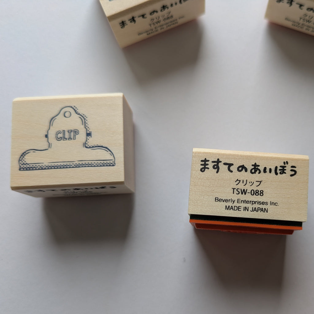 Wooden stamps with text and graphics on a light gray background