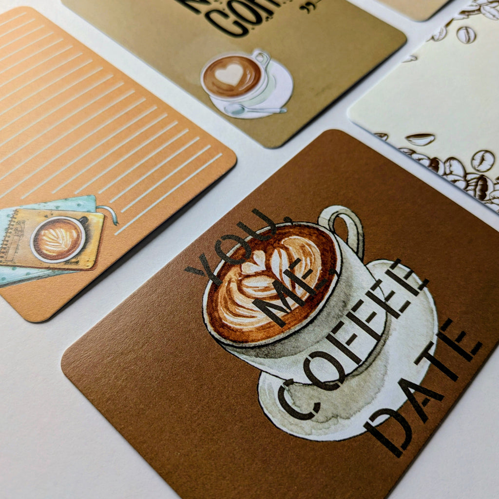 Set of coffee-themed coasters with designs and text on a white surface