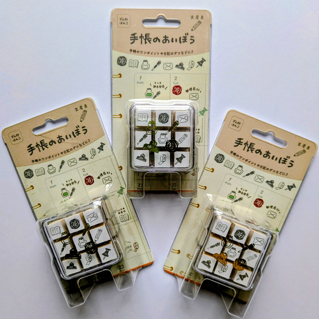 Three packages of small square stamps with illustrations on a white background