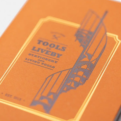 Orange notebook with a black and white illustration on a white background