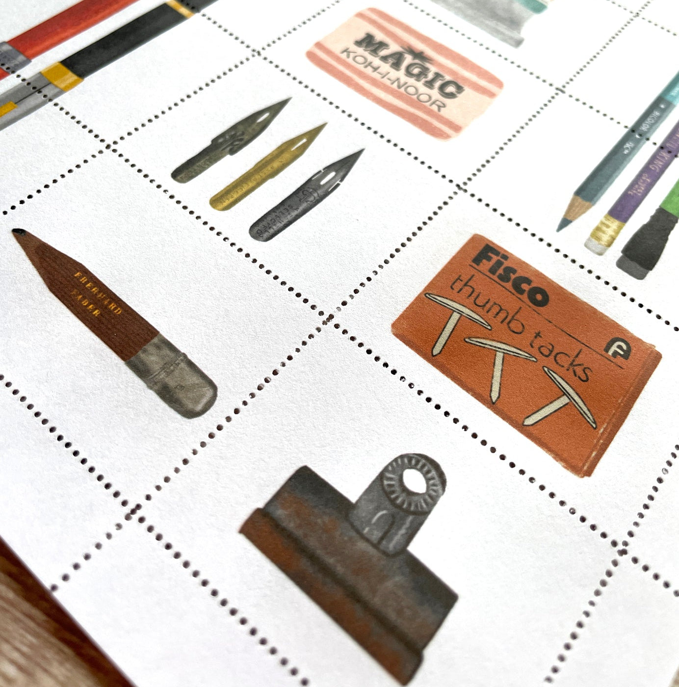 Collection of vintage office supplies on a stamp grid-patterned surface
