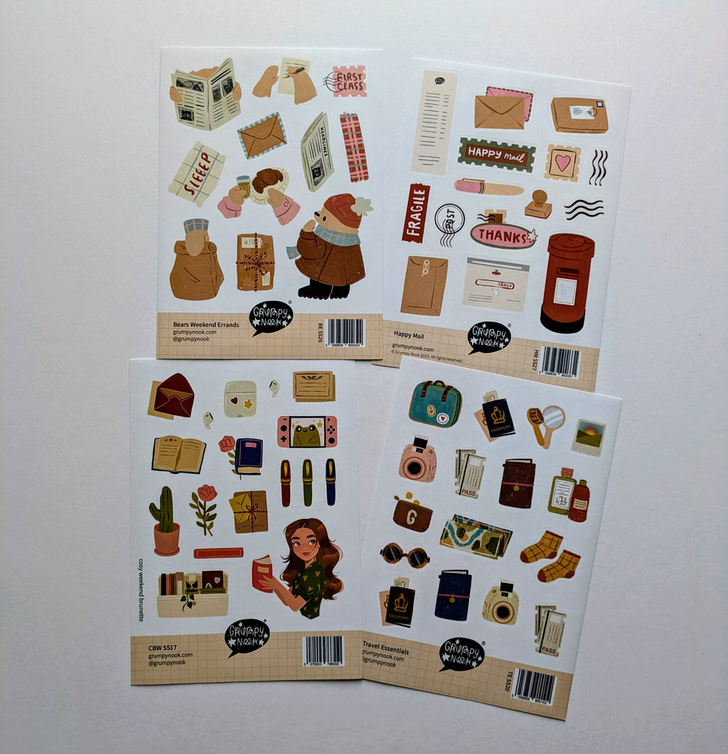 Four sheets of decorative stickers with various cosy themed illustrations on a white background